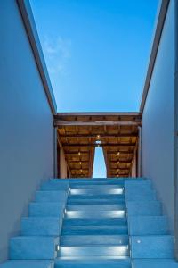 a set of blue stairs with a blue sky in the background at Horizon Blu Boutique Hotel in Kalamata