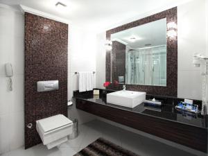a bathroom with a sink and a mirror at Surmeli Istanbul Hotel in Istanbul