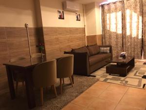 a living room with a couch and a table at Magic Studio Pool View, New Cairo in Cairo