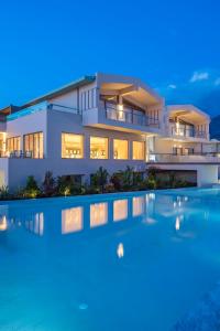 a villa with a swimming pool at night at Horizon Blu Boutique Hotel in Kalamata