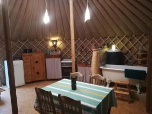 a kitchen with a table and chairs in a yurt at La yourte au fonds du jardin in Xhoris +8 photos