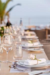 a long table with plates and wine glasses at Horizon Blu Boutique Hotel in Kalamata
