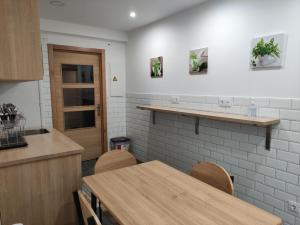 a kitchen with a table and chairs in a room at Pension Cando in Porriño