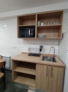 a kitchen with a sink and a microwave at Pension Cando in Porriño