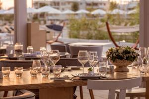 a wooden table with wine glasses on a patio at Horizon Blu Boutique Hotel in Kalamata