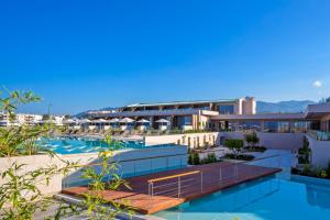 a hotel room with a pool and a large building at Horizon Blu Boutique Hotel in Kalamata