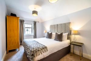 een slaapkamer met een groot bed en een raam bij Middlethorpe Manor - No 5 Lazy Days and Explore in York