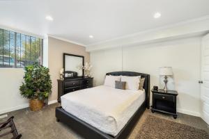 a bedroom with a bed and two night stands and a window at Amazing Kaison's Condo in Salt Lake City