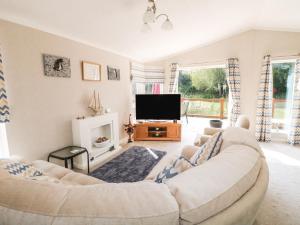 a living room with a couch and a tv at Stonesthrow in Grantham