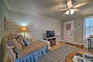a living room with a couch and a flat screen tv at Cozy Brenham Cottage with Private Patio and Yard! in Brenham