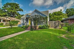 a house with a green yard with a fence at Cozy Brenham Cottage with Private Patio and Yard! in Brenham