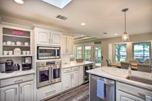 a kitchen with white cabinets and a counter top at Idyllic Remodeled Lakefront Retreat with Fire Pit! in Malakoff
