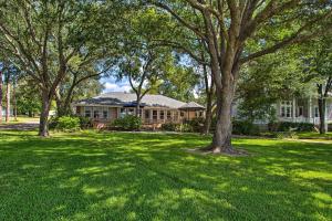 a house with trees in front of a yard at Remodeled Cedar Creek Lake Retreat with Fire Pit! in Malakoff