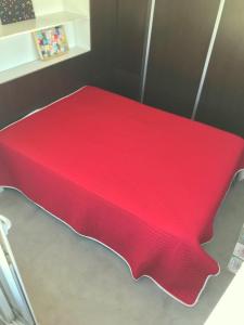 a red bedsheet on a table in a room at Viví Home in Mar del Plata