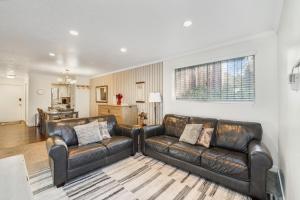 a living room with two leather couches at Amazing Kaison's Condo in Salt Lake City