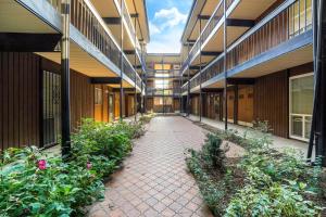 an empty hallway of a school building with plants at Amazing Kaison's Condo in Salt Lake City