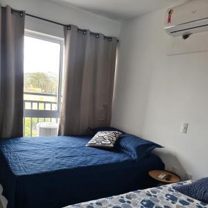 a bedroom with two beds and a window at Flat 308 in Teresina