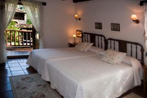 En eller flere senger på et rom på Posada San Pelayo