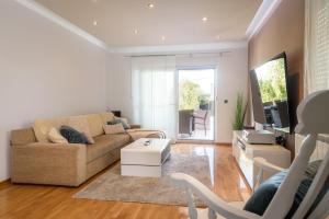 a living room with a couch and a table at Villa Jerkovic in Metković