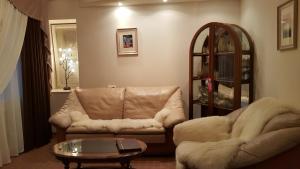 a living room with a couch and a coffee table at Hotel Geolog in Surgut