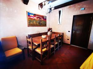 a dining room with a wooden table and chairs at Chalet Mon Amour in Campo di Giove