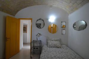 a bedroom with a bed and mirrors on the wall at La casa della mia famiglia in Rome