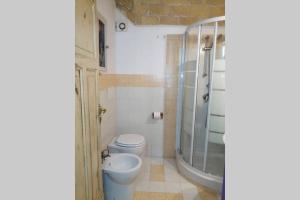 a bathroom with a toilet and a shower at La casa della mia famiglia in Rome