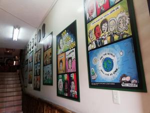 a bunch of posters on a wall in a building at Flying Donkey in Otavalo