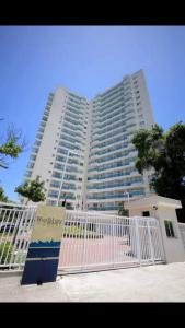 a large white building with a fence in front of it at Rio Stay -Apart -Hotel in Rio de Janeiro