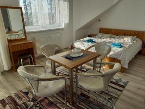 a room with a table and chairs and a bed at Hotel Vyšehrad in Turčianske Teplice