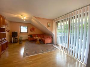 a living room with a couch and a tv at Ferienhaus Rivera in Riveris