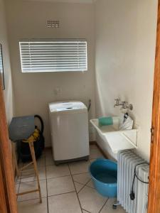 a bathroom with a sink and a toilet in it at Stay@51 Botha in Oudtshoorn