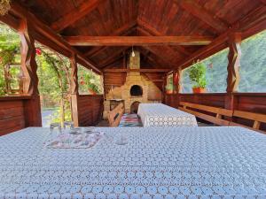 a large wooden room with a table and a fireplace at Casa Cerbu in Arieşeni