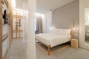 a bedroom with a bed and a tiled wall at Terra del Sasso Suites - Free Wifi e Netflix in Sasso di Castalda
