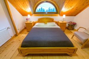 a bedroom with a large bed in a room with a window at Willa Sosna in Kościelisko