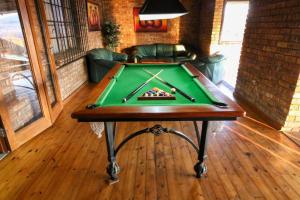 a pool table in a living room with afits at Waterval Self-Catering Holiday Home in Sabie