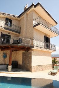 a house with a balcony and a swimming pool at Villa Elisabetta in Pompei