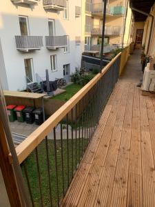 a balcony of a building with a wooden deck at Vega - Free Parking - Self Checkin in Graz
