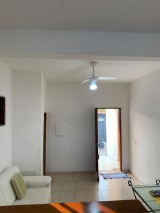 a living room with a couch and a ceiling fan at arco iris in Camburi