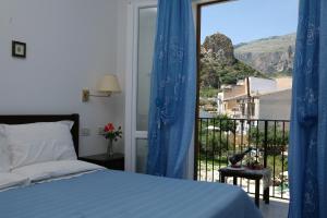 a bedroom with a bed and a window with a view at Torre Bennistra in Scopello