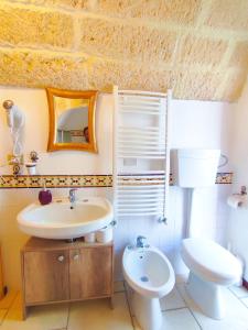 uma casa de banho com um lavatório e um WC em La Dimora della nonna Rosina em Galatone