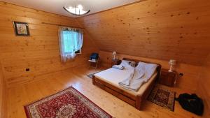 a bedroom with a bed in a wooden room at Dom Kormaniak in Korbielów