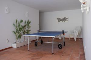 a ping pong table in the corner of a room at Ofir Beach House Bonança in Esposende