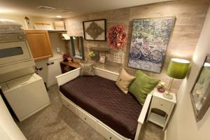 a small bedroom with a bed in a tiny house at Cabernet Cottage in Cottonwood