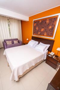 a bedroom with a large bed and a painting on the wall at Posada Blanca Hotel Boutique in Piura