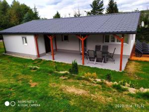 a small white house with a black roof at Holiday home in Svahova - Erzgebirge 41640 in Svahová