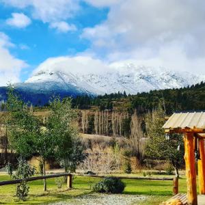a view of a snow covered mountain in the distance at La Maruca in El Hoyo