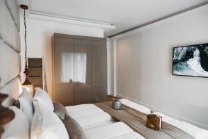 a bedroom with a large bed with white pillows at The Berg's 3 in Ocna-Mureşului