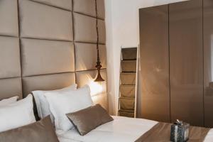 a bedroom with a bed with white sheets and pillows at The Berg's 3 in Ocna-Mureşului