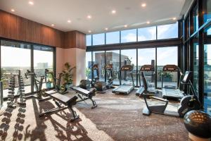a gym with treadmills and cardio equipment in a building at Crowne Plaza Adelaide by IHG in Adelaide